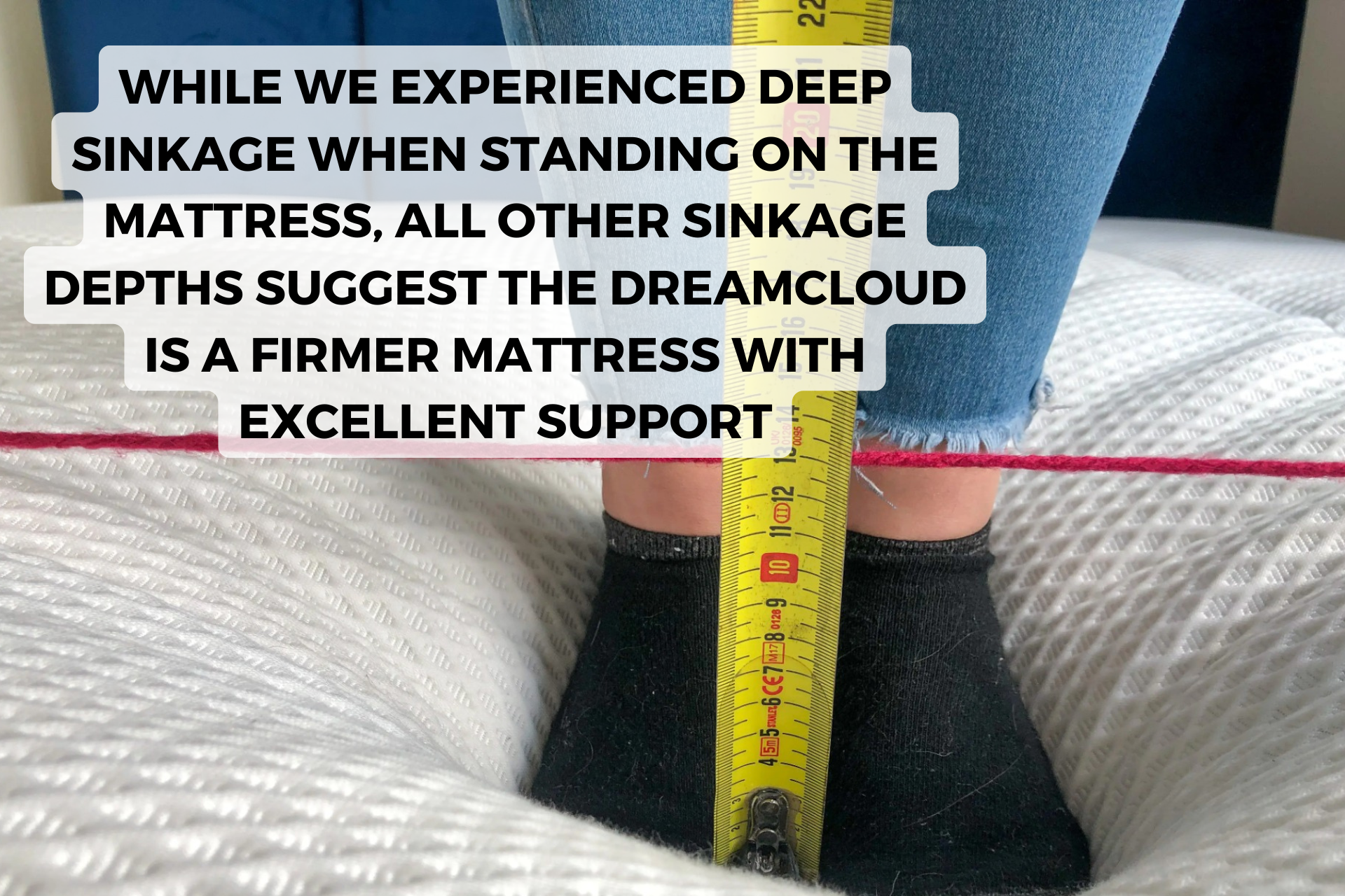 Standing in the middle of DreamCloud mattress with measuring tape